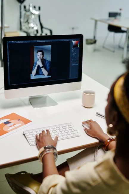 why-choose-us A person using a laptop to browse stock photo websites. Freelancing work in a cozy setting.